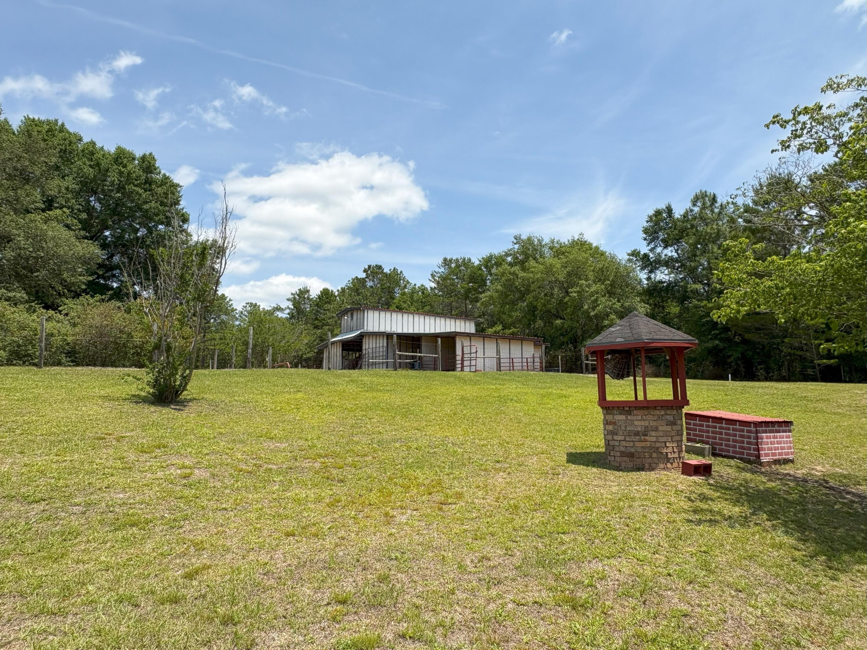 3864 Bear Head Road Crestview, FL 32539 - Photo 43 of 57 a backyard of a house with table and chairs