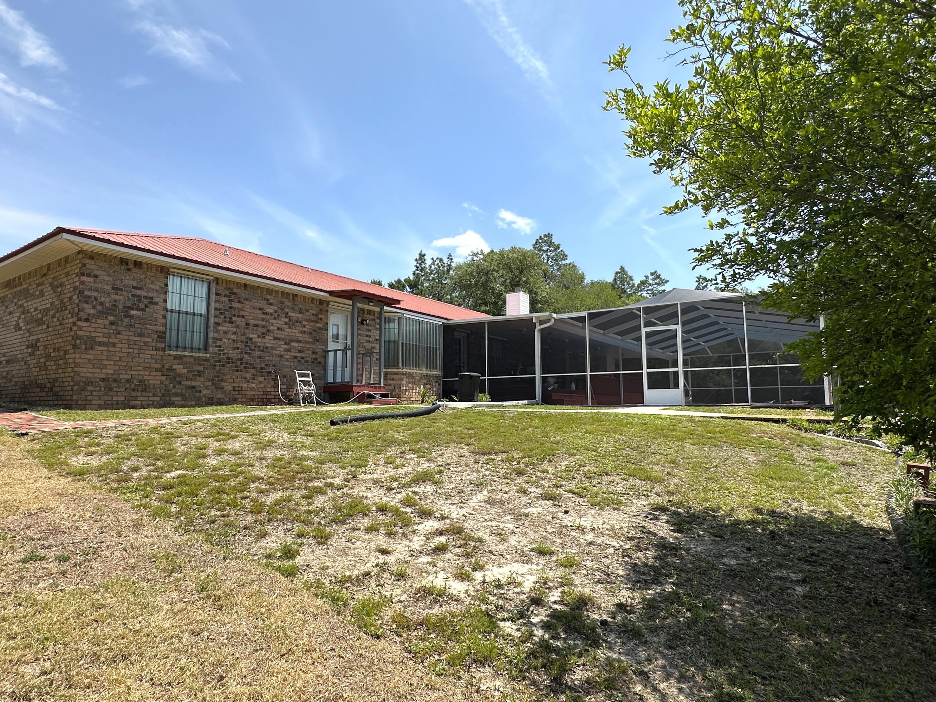 3864 Bear Head Road Crestview, FL 32539 - Photo 48 of 57 a view of an house with backyard space and balcony
