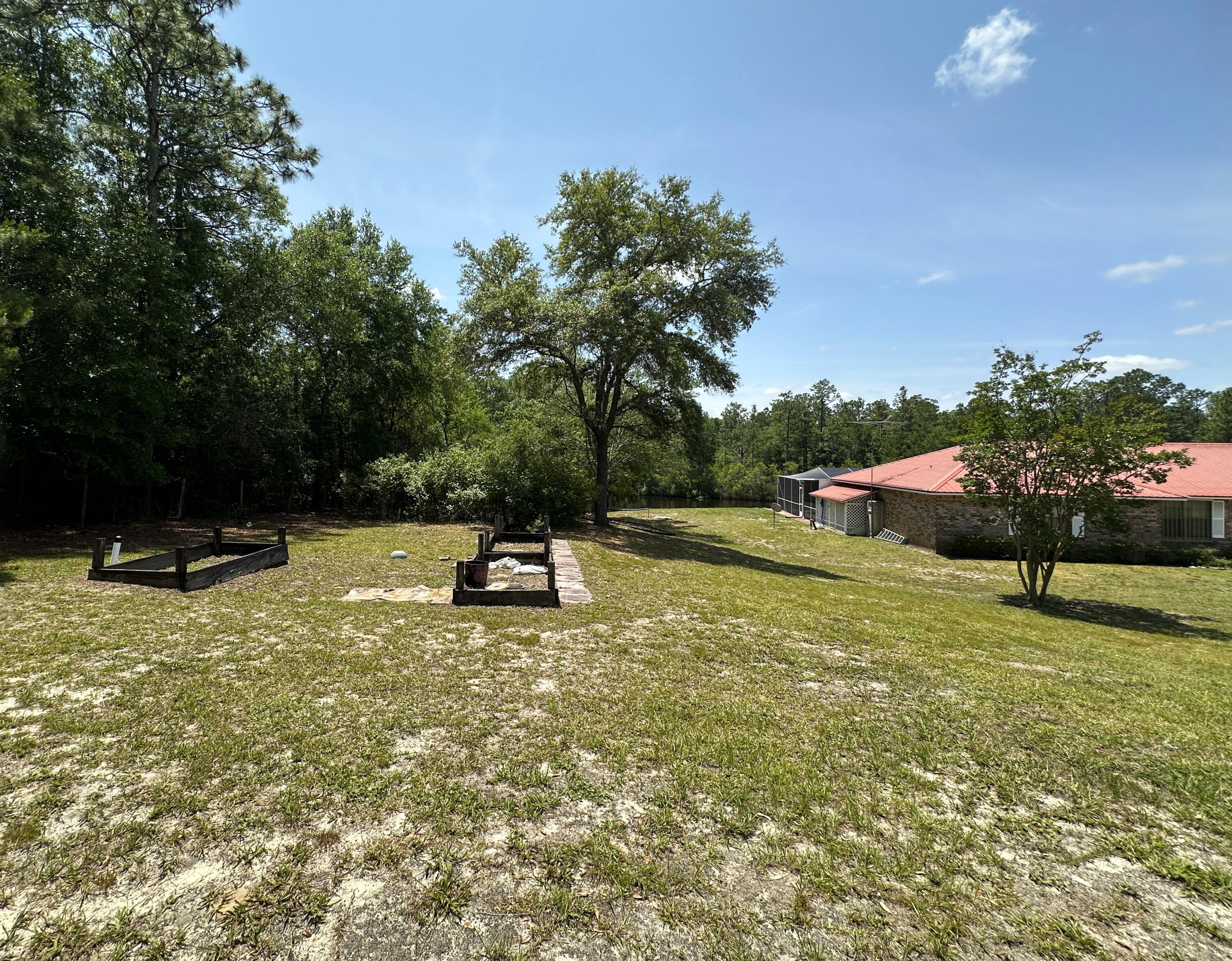3864 Bear Head Road Crestview, FL 32539 - Photo 53 of 57 a swimming pool with wooden fence
