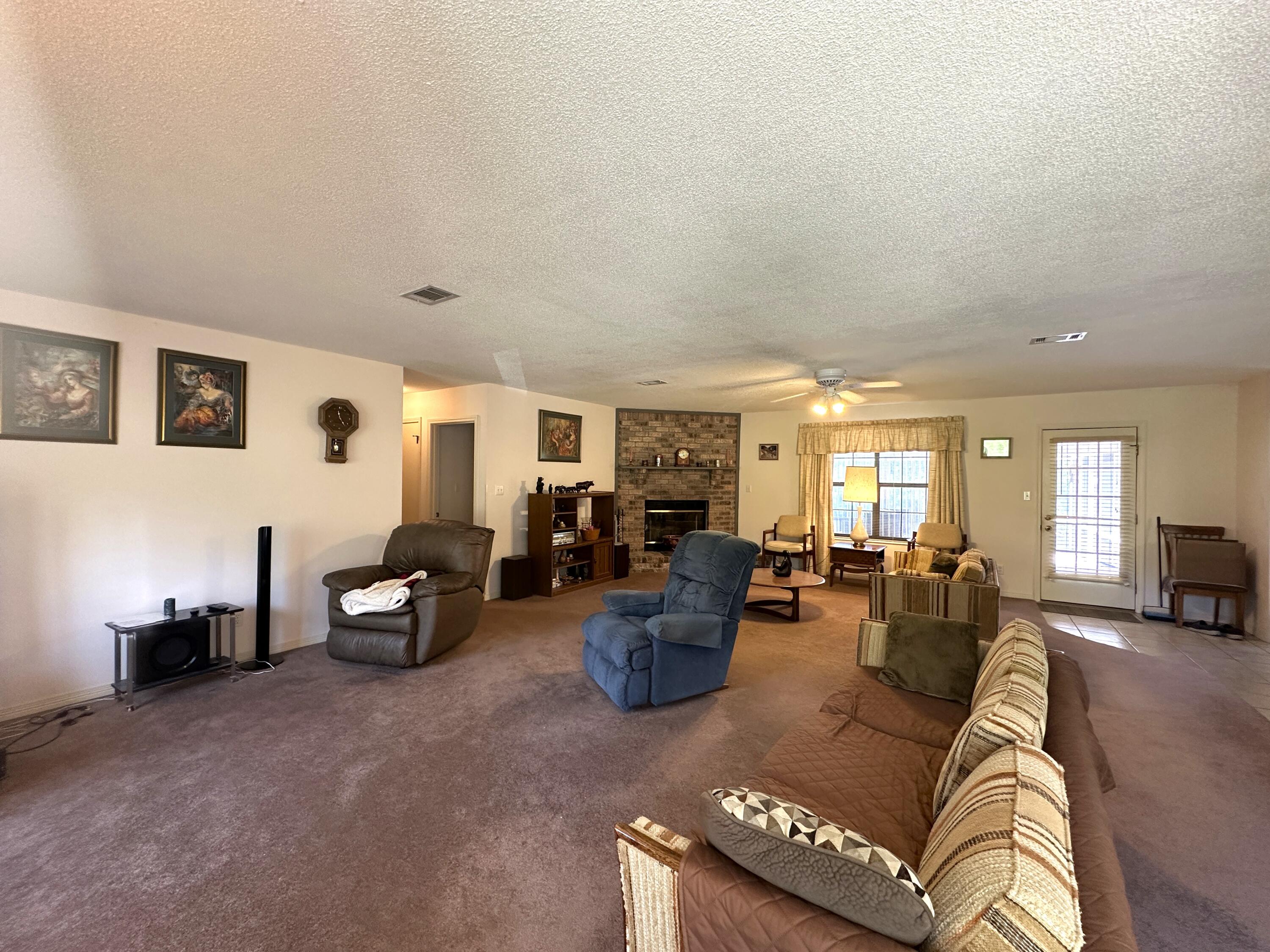 3864 Bear Head Road Crestview, FL 32539 - Photo 6 of 57 a living room with furniture and a large window