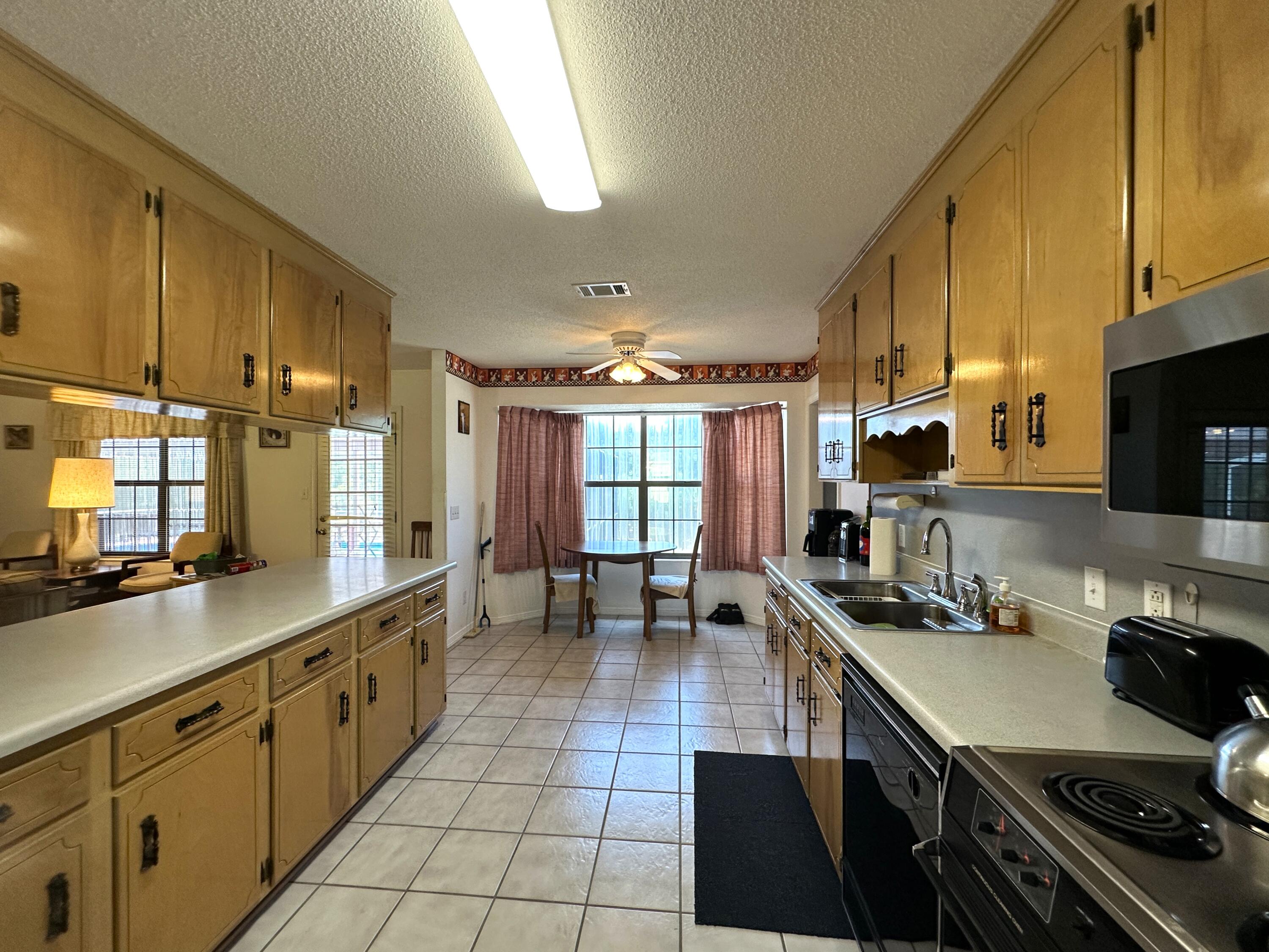 3864 Bear Head Road Crestview, FL 32539 - Photo 9 of 57 a kitchen with stainless steel appliances a sink stove and cabinets