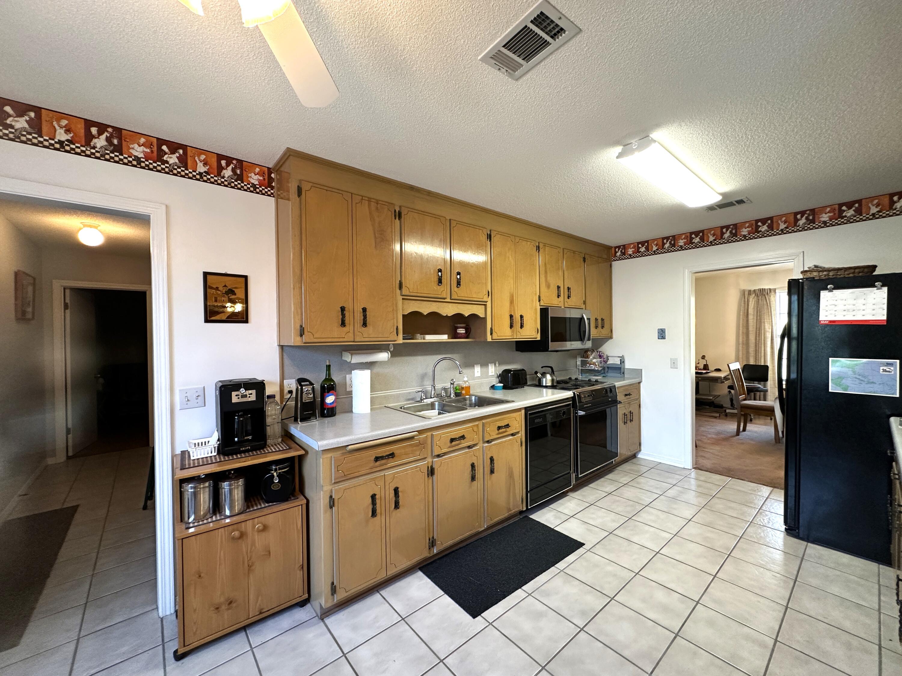 3864 Bear Head Road Crestview, FL 32539 - Photo 10 of 57 a kitchen with stainless steel appliances granite countertop a refrigerator and a stove top oven
