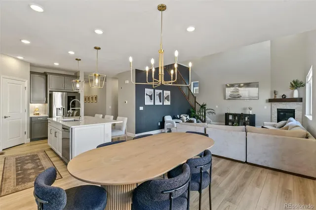 a kitchen with a table chairs refrigerator and microwave