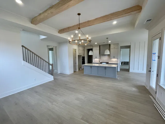 a view of a kitchen and chandelier in a room
