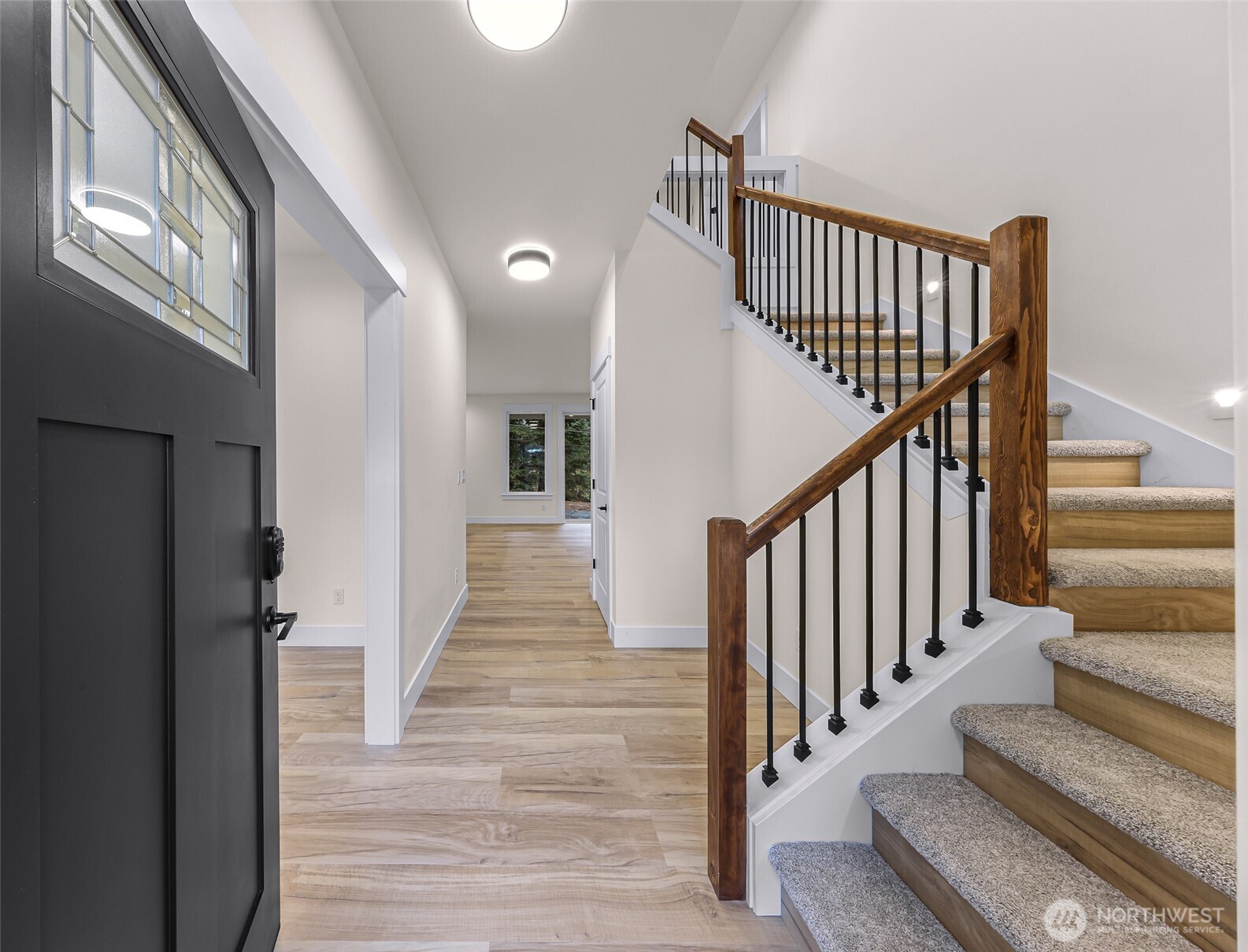 511 West 2nd Street Cle Elum, WA 98922 - Photo 8 of 35 a view of staircase with lots of frames on wall and wooden floor