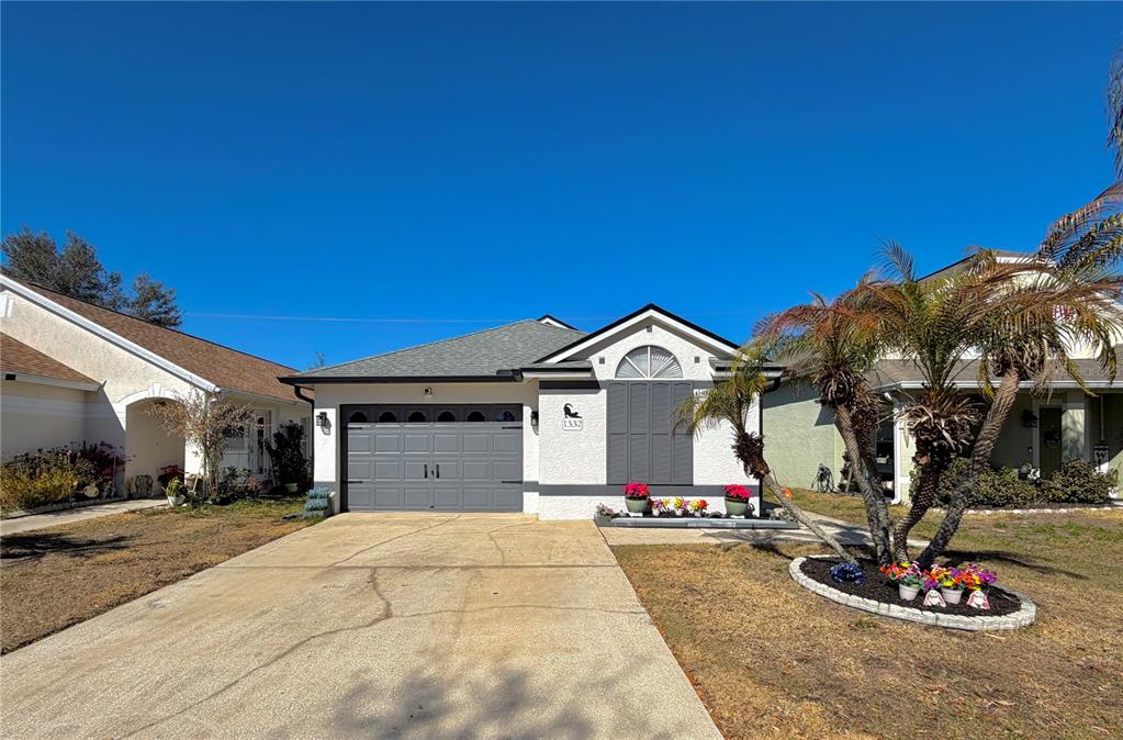 1332 Dew Bloom Road Valrico, FL 33594 - Photo 1 of 22 a front view of house with garage