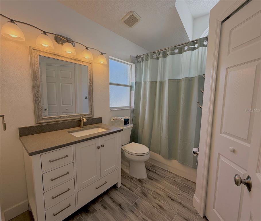 1332 Dew Bloom Road Valrico, FL 33594 - Photo 12 of 22 a bathroom with a double vanity sink toilet and shower