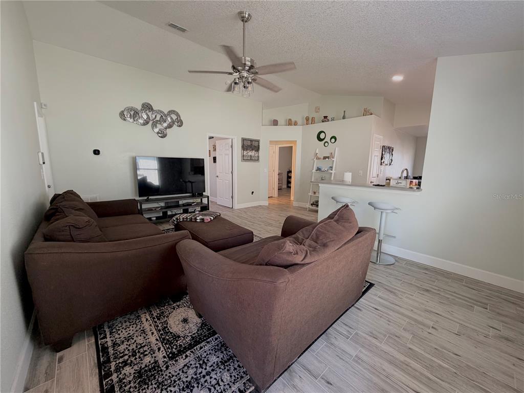 1332 Dew Bloom Road Valrico, FL 33594 - Photo 3 of 22 a living room with furniture and a flat screen tv
