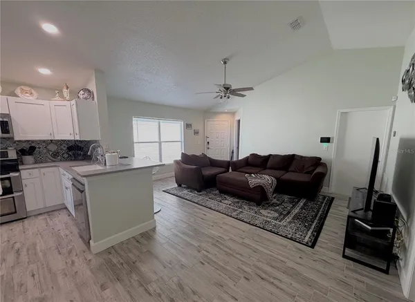 a living room with furniture and a flat screen tv
