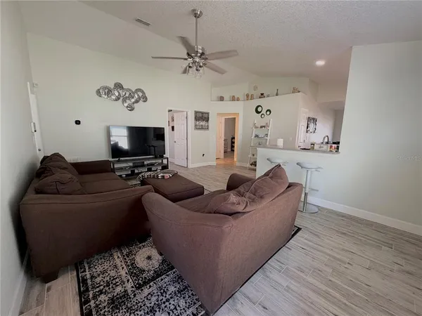 a kitchen with stainless steel appliances granite countertop a refrigerator a stove and a wooden floors