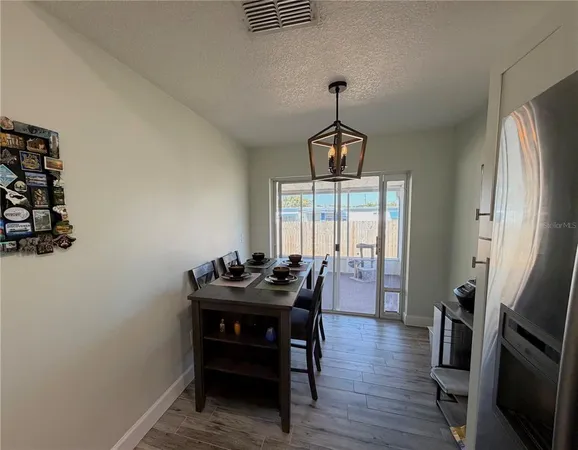 a dining room with furniture and wooden floor
