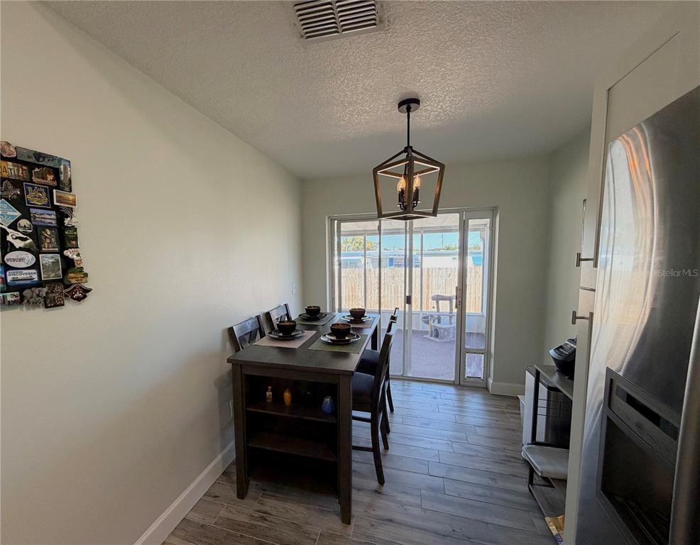 1332 Dew Bloom Road Valrico, FL 33594 - Photo 8 of 22 a dining room with furniture and wooden floor