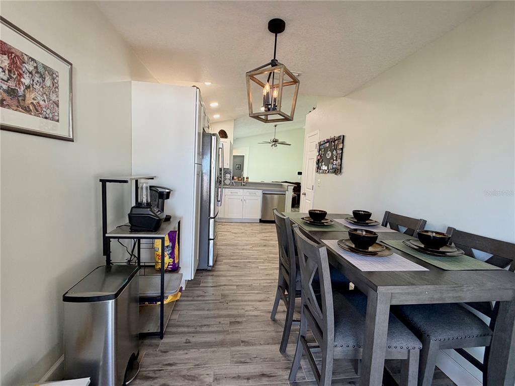 1332 Dew Bloom Road Valrico, FL 33594 - Photo 9 of 22 a view of a dining room with furniture and wooden floor