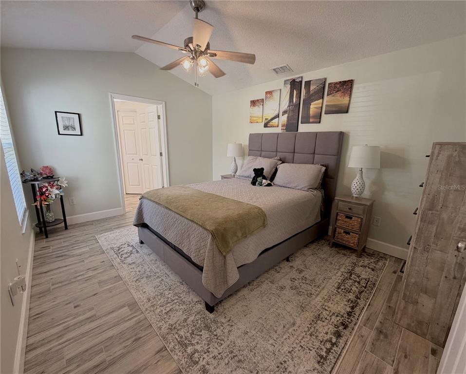 1332 Dew Bloom Road Valrico, FL 33594 - Photo 10 of 22 a bedroom with a bed and a chandelier