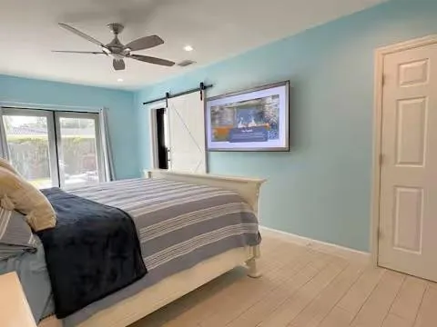a bedroom with a bed and a painting on the wall