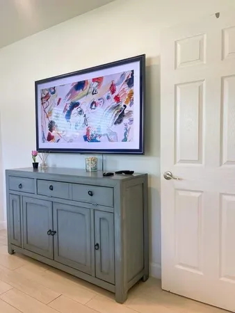 a view with cabinets and painting on the wall