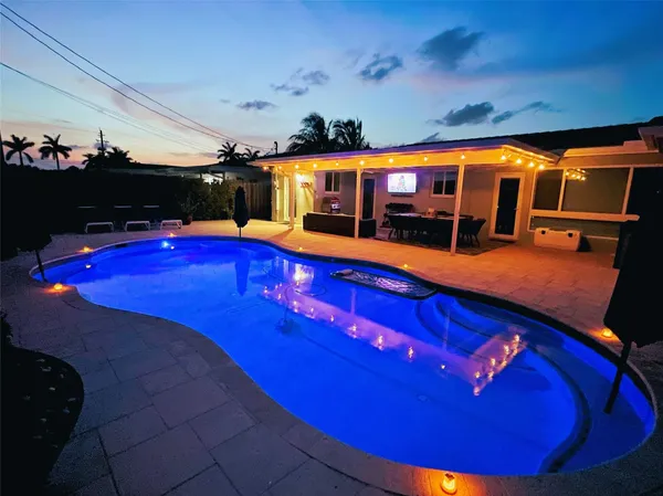 a view of swimming pool with seating space