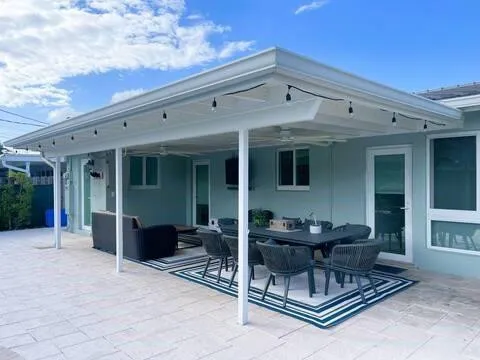 a view of a patio with table and chairs