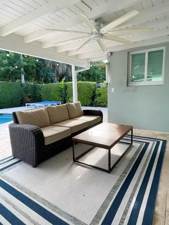 a outdoor living space with furniture and a rug