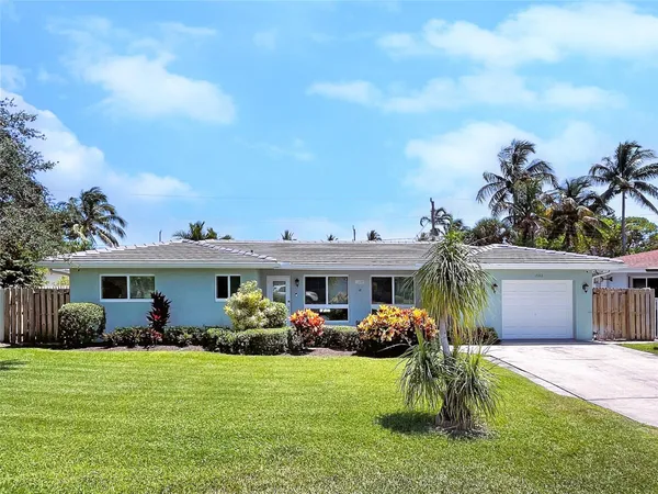 a front view of house with yard and outdoor seating