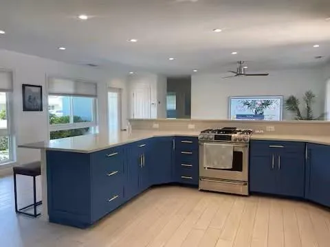 a kitchen with stainless steel appliances granite countertop a stove a sink and a refrigerator