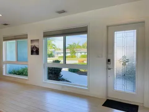 a view of an entryway with wooden floor and door