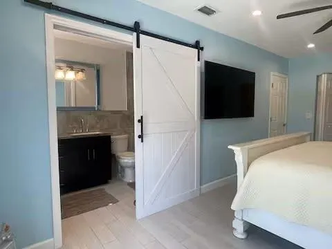 a bedroom with a bed and a television