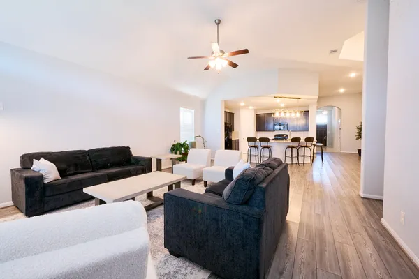 a living room with furniture and wooden floor