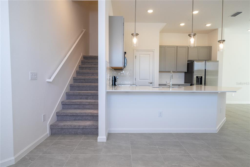 10592 Ebb Tide Lane Orlando, FL 32821 - Photo 11 of 85 a view of kitchen with kitchen island and stainless steel appliances