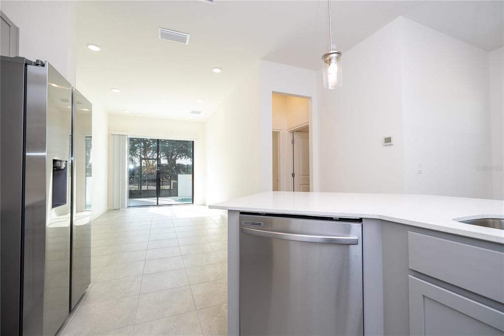 10592 Ebb Tide Lane Orlando, FL 32821 - Photo 19 of 85 a kitchen with stainless steel appliances a refrigerator and a sink