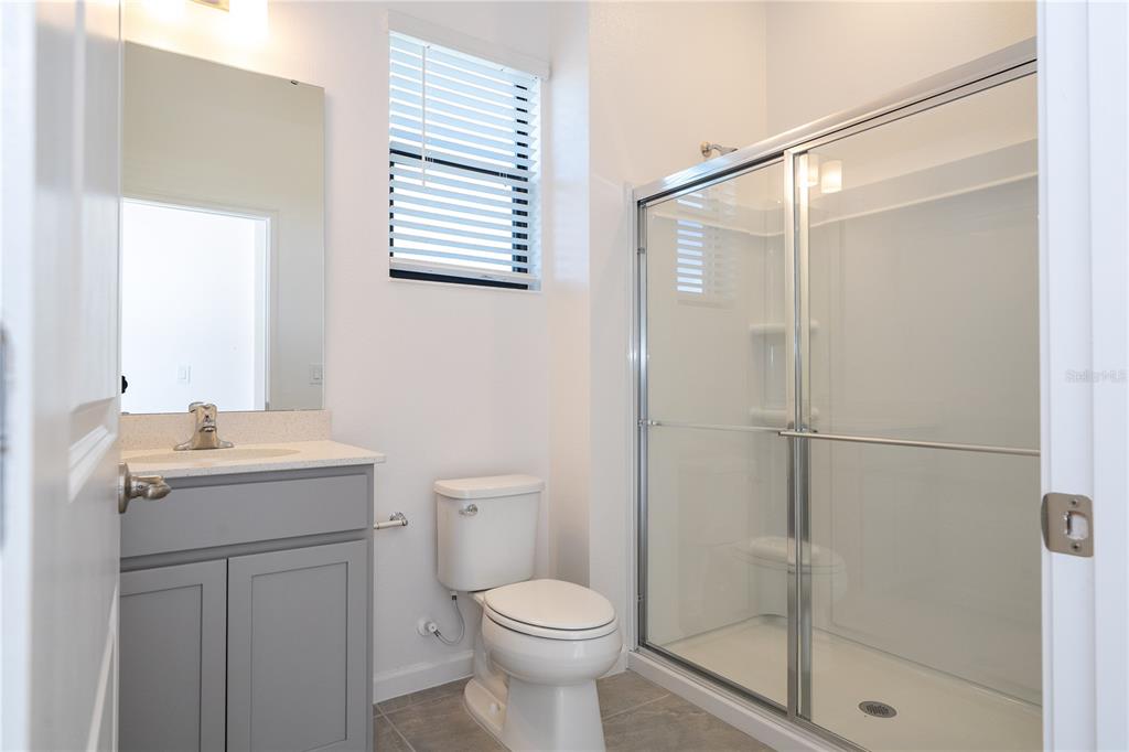 10592 Ebb Tide Lane Orlando, FL 32821 - Photo 34 of 85 a bathroom with a toilet sink and a shower