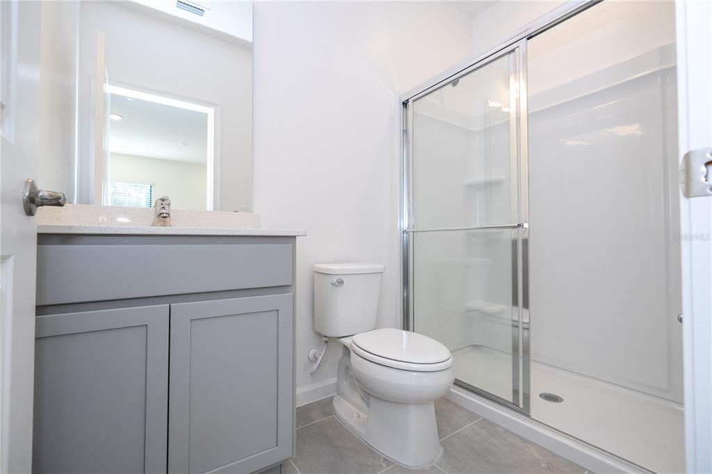 10592 Ebb Tide Lane Orlando, FL 32821 - Photo 45 of 85 a bathroom with a sink a toilet and shower