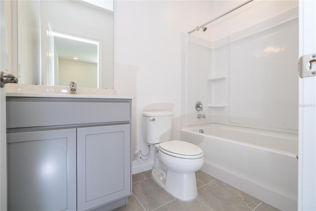 10592 Ebb Tide Lane Orlando, FL 32821 - Photo 50 of 85 a bathroom with a sink toilet and shower