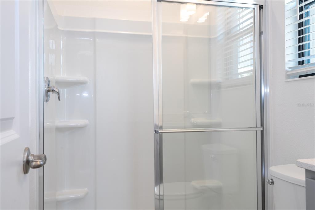 10592 Ebb Tide Lane Orlando, FL 32821 - Photo 56 of 85 a bathroom with a glass shower door