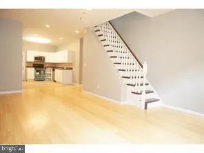 a view of kitchen and hall with wooden floor