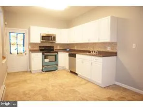 a kitchen with stainless steel appliances granite countertop a stove top oven and sink