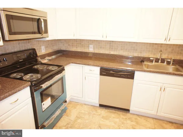 a kitchen with a stove and a microwave