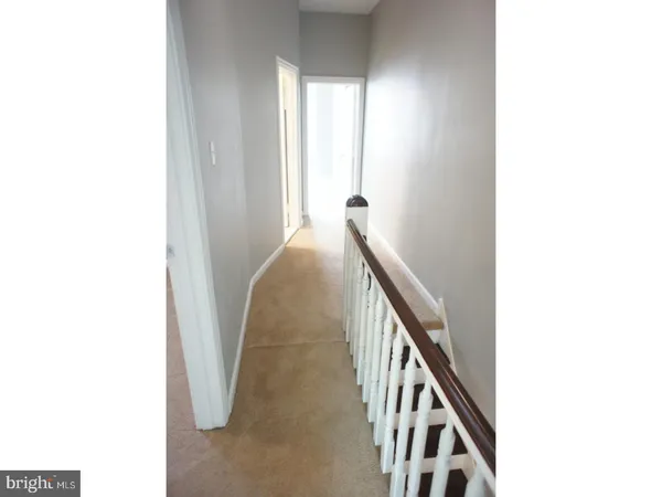 a view of a hallway with stairs