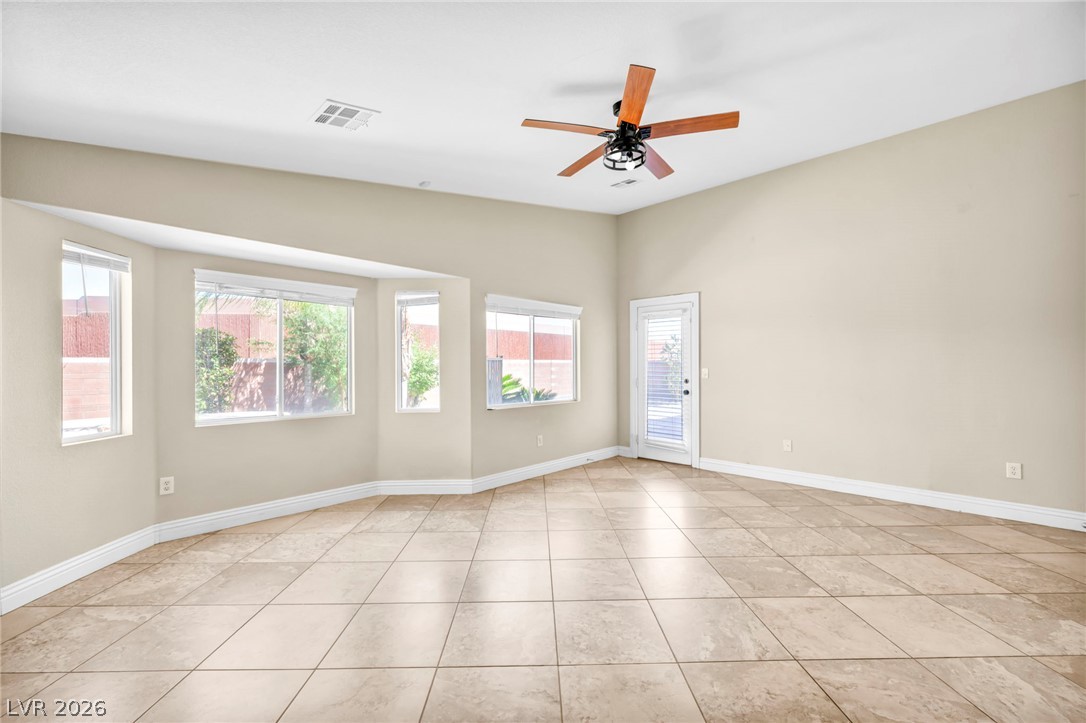 6405 North Raptor Court North Las Vegas, NV 89084 - Photo 32 of 66 Natural light floods this inviting living space, offering tranquil outdoor views.