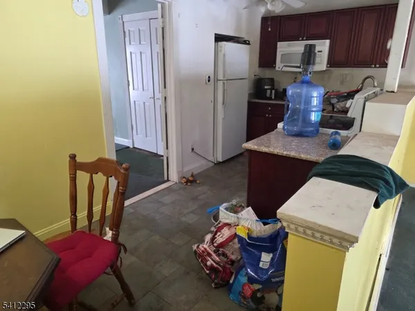 a kitchen with stainless steel appliances kitchen island granite countertop a refrigerator and a stove