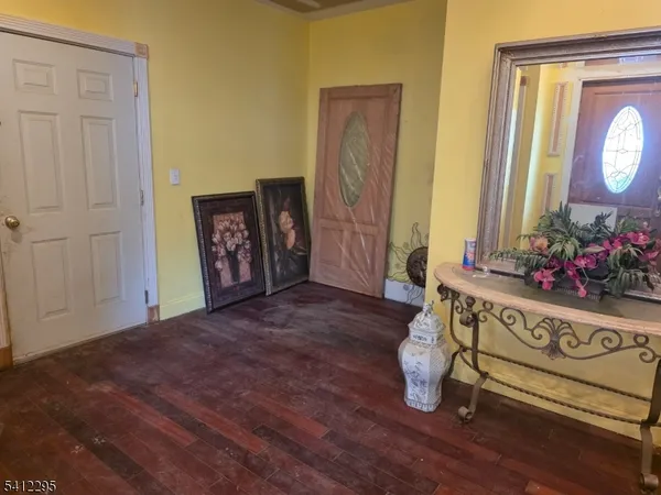 a room with gym equipment and wooden floor