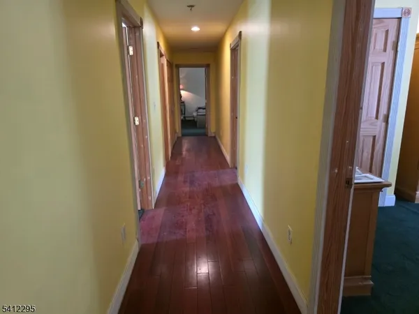 a view of hallway with wooden floor
