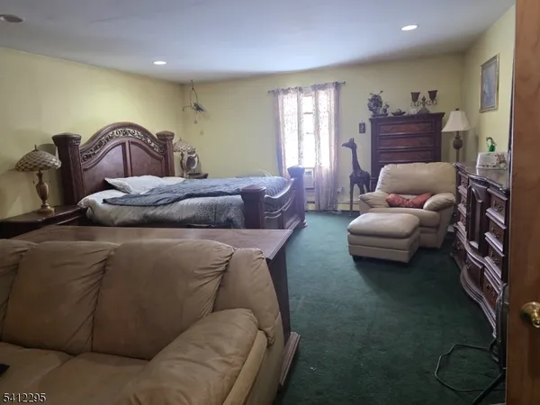 a bedroom with furniture and a window