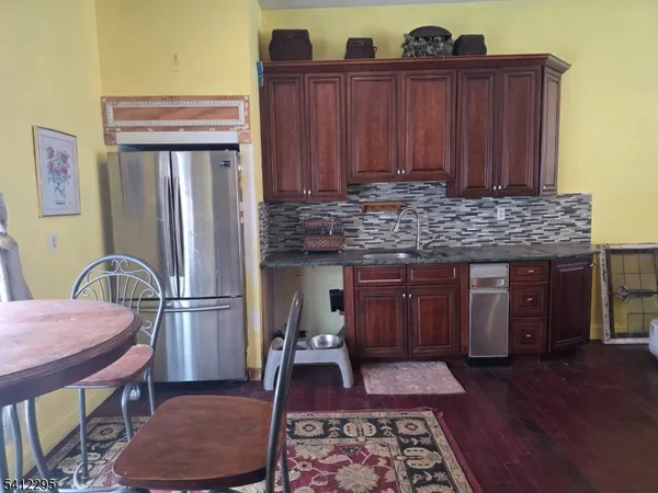a kitchen with granite countertop wooden cabinets and stainless steel appliances