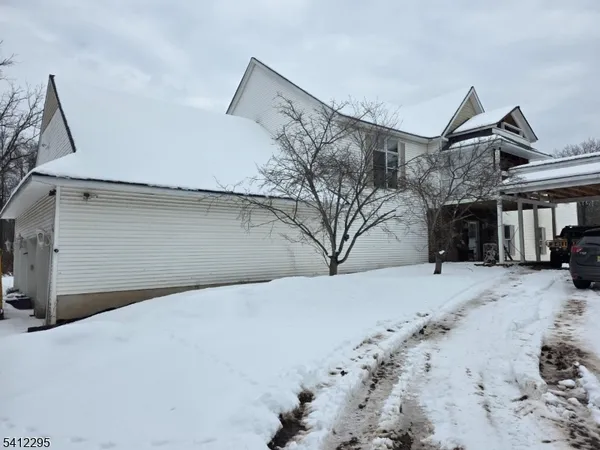 a view of a house with a snow in the yard