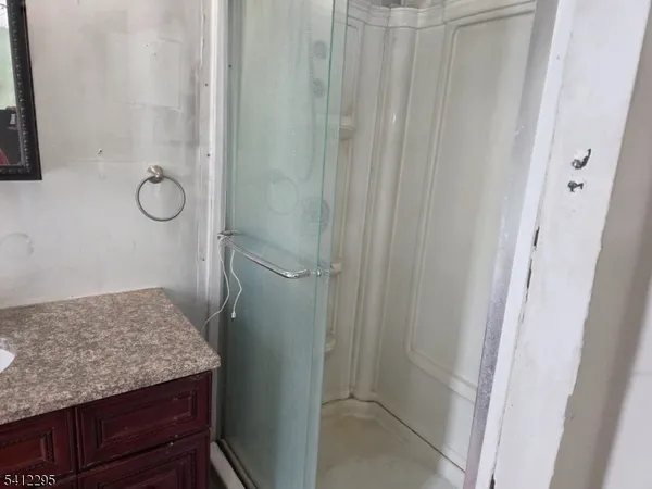 a bathroom with a granite countertop sink and vanity