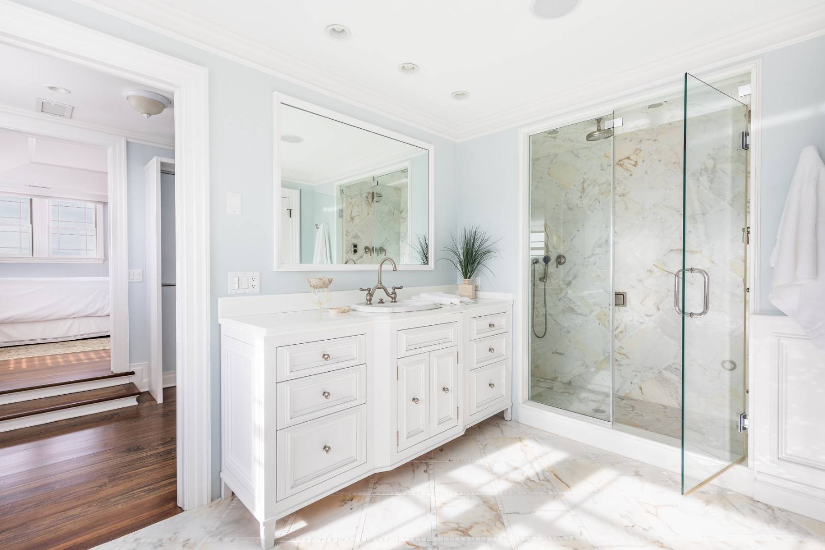 351 Kings Point Road East Hampton, NY 11937 - Photo 12 of 34 a spacious bathroom with a shower sink and mirror
