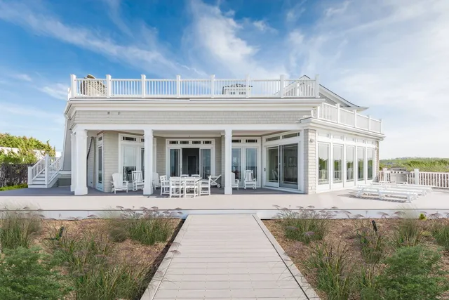 a front view of a building with a garden