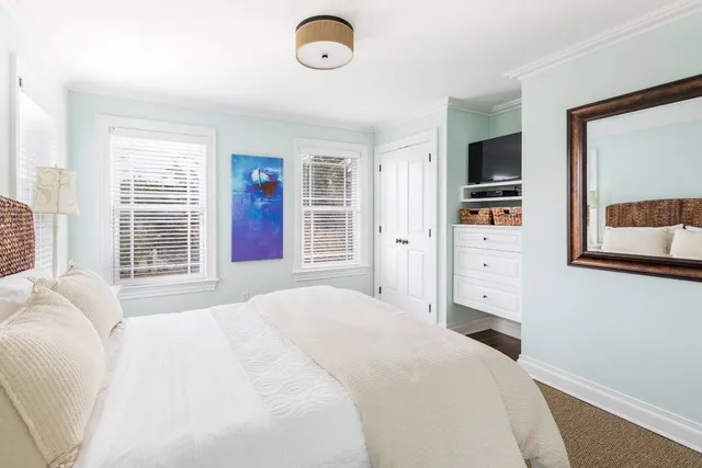 a bedroom with a bed and a television