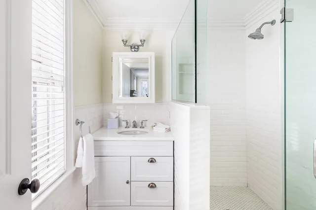 a bathroom with a sink toilet and shower